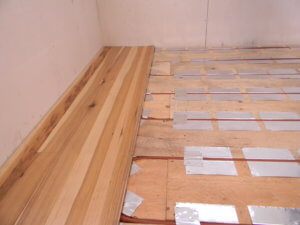 Floating floor installed over radiant heating installation.