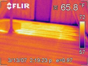 Photo showing difference in heat output for an area with and without heat transfer plates.